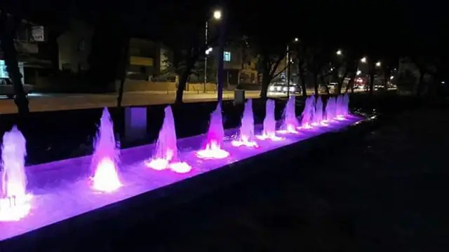 Row of illuminated jets along a linear basin