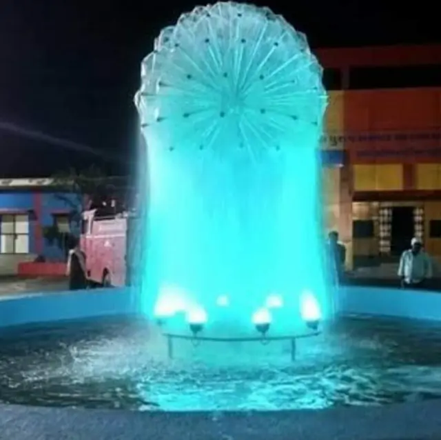 Water-sphere fountain with cyan lighting