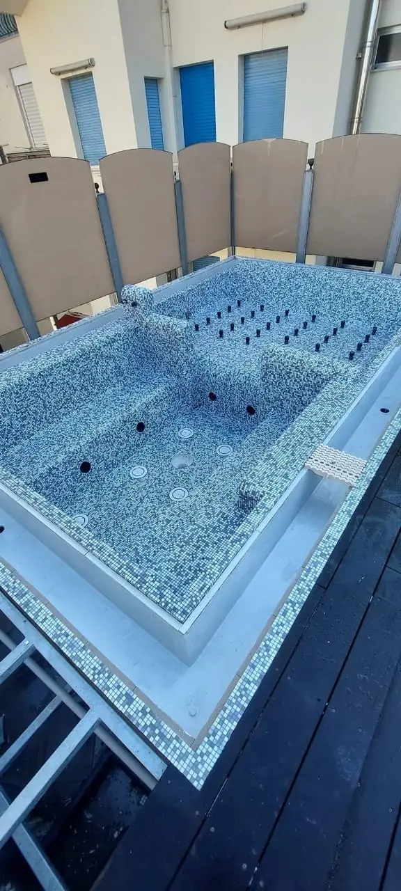 Raised spa finished in mosaic, ready for filling