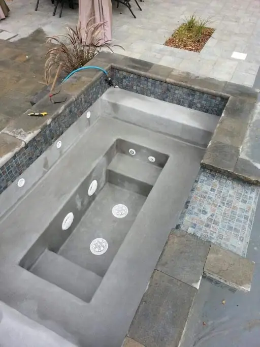 Rendered spa shell with jet fittings before tiling