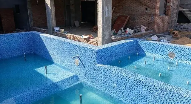 Completed pool: blue mosaic and integrated water bench