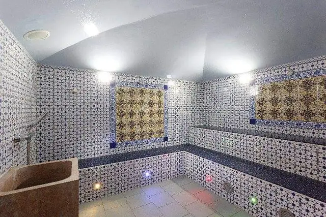 Hammam with zellige walls and stone basin