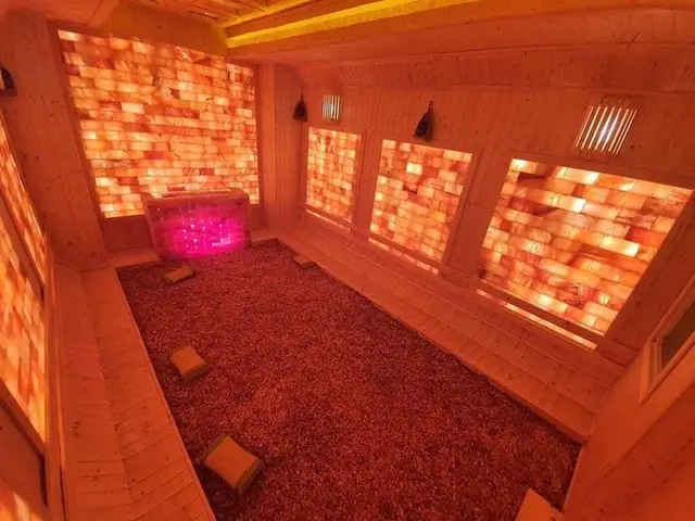 Salt room with salt-granule floor and warm lighting