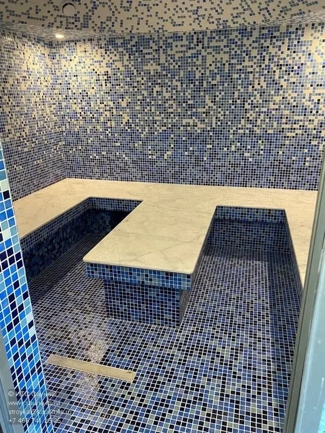 Steam room with U-shaped bench in mosaic